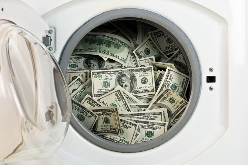 16034741 - money in washing machine close up
